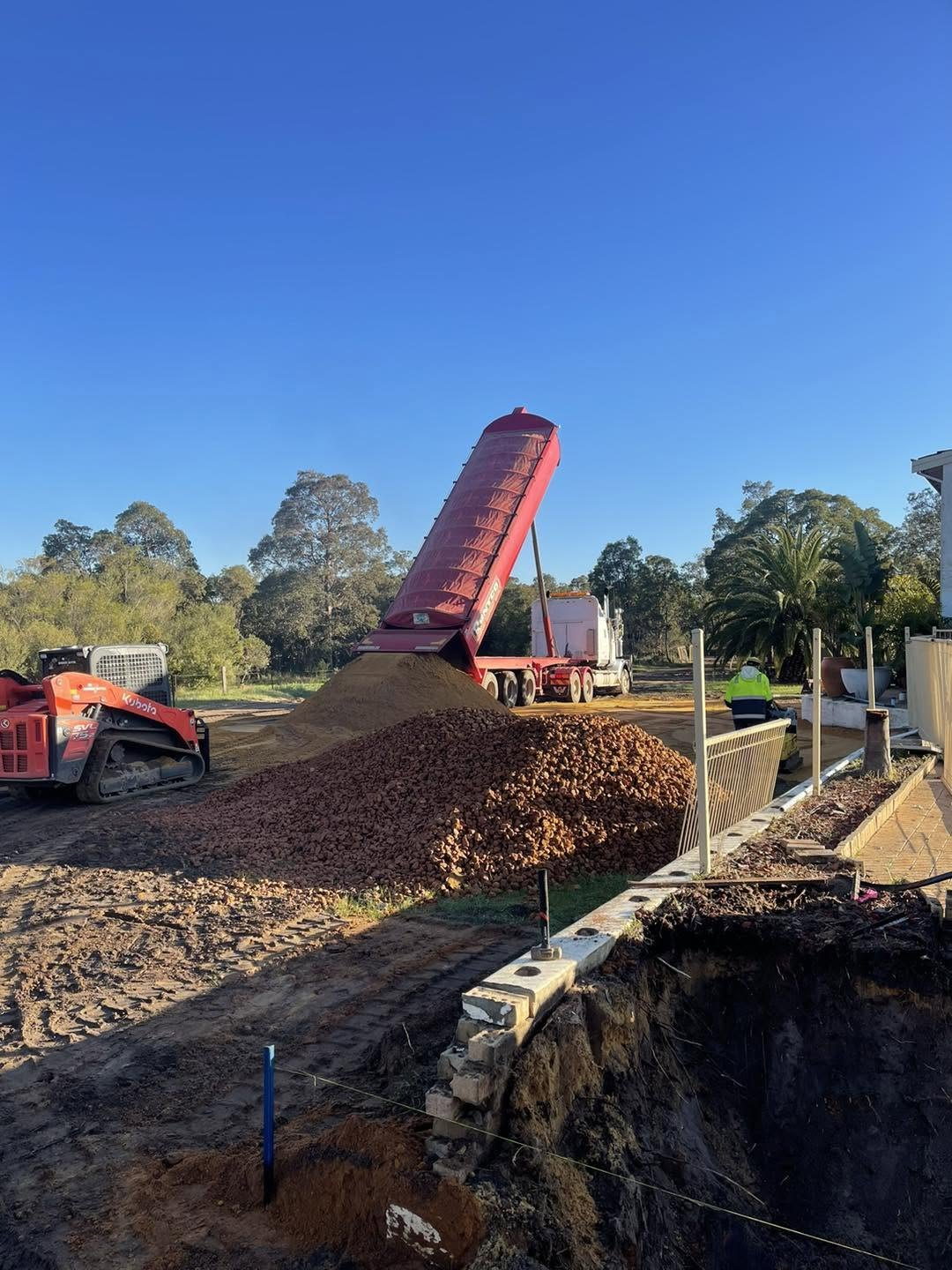 Conveyor spreading gravel supplied by Gidge Civil