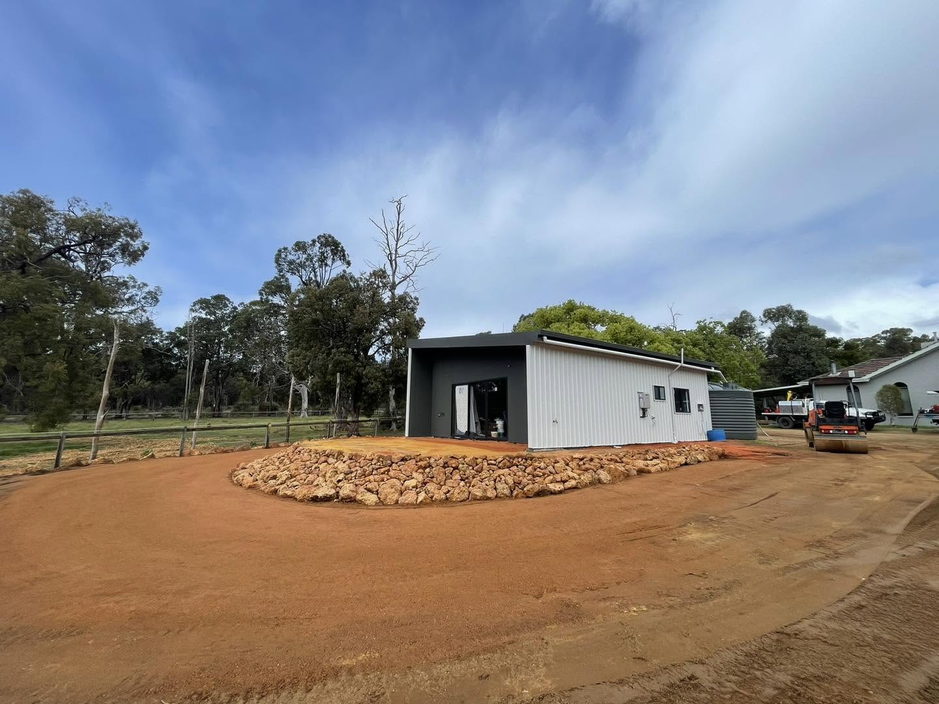 Finished shed pad with rock feature garden
